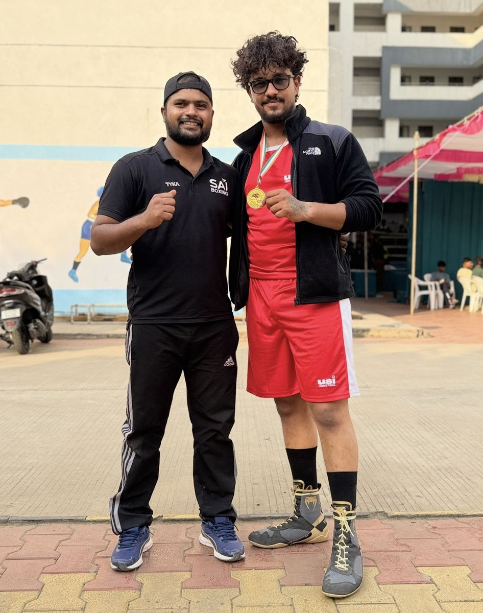 Moksha Chandel wearing his Khel Mahakumbh gold medal with his coach